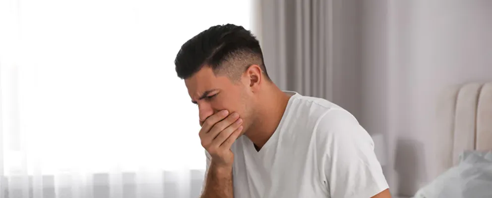 man having nausea problem and suffering for the treatment