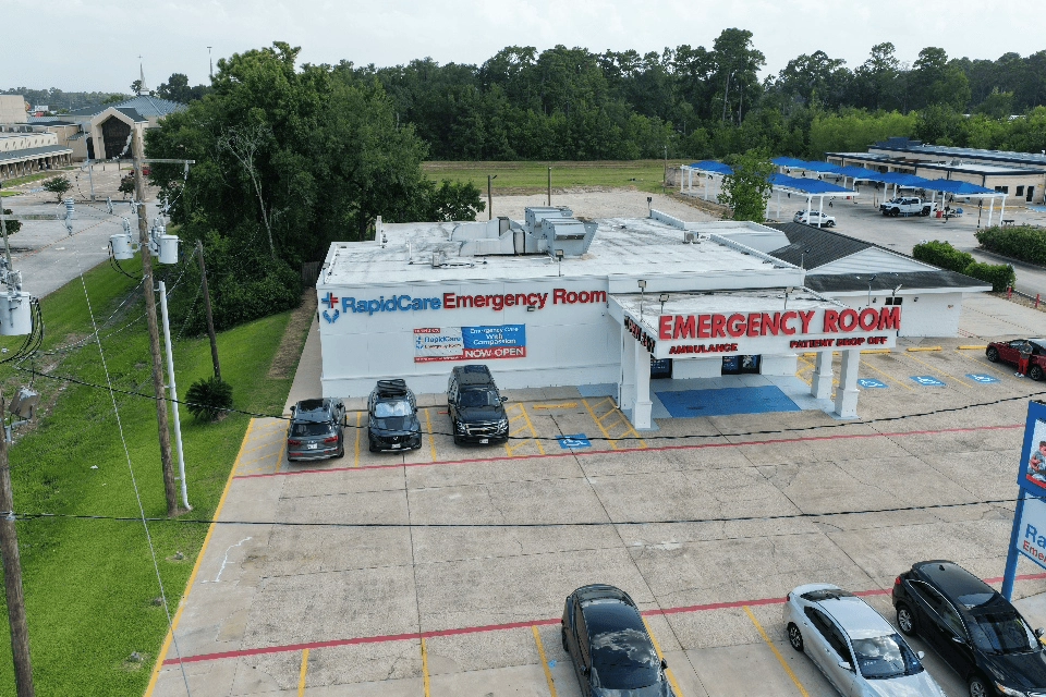 RapidCare Emergency Room building and parking area serving Kingwood and Porter, TX.